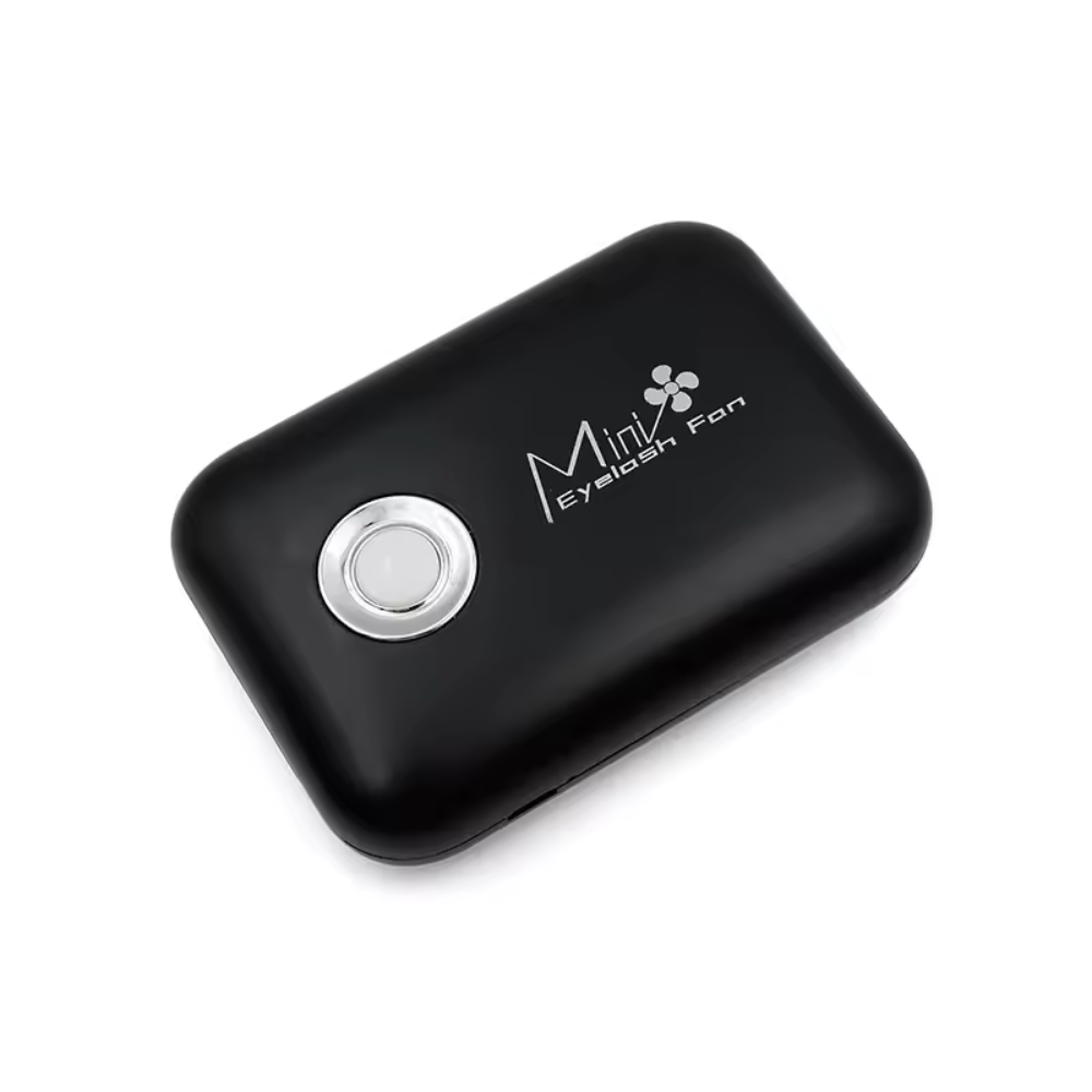 lashfan-black-2 Black handheld device with a silver button on a white background
